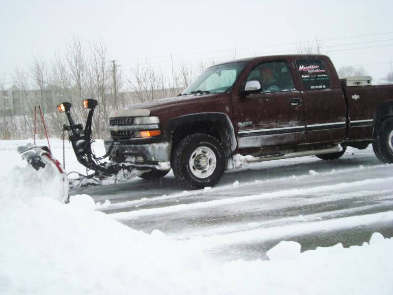 Mueller Sprinklers Truck removing snow for a commercial property.